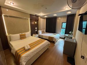 a hotel room with two beds in a room at Jewel Hotel in Ho Chi Minh City +54 photos