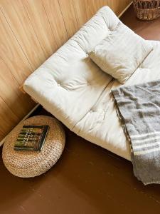 a white couch with a book on a table at Gård Fra 1770 Med Flydende Sauna Ved Søen in Hennseid