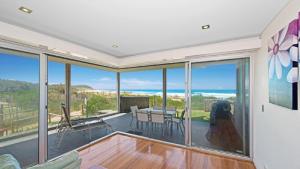 a living room with a view of the ocean at The Pavillion 1 - Beachfront in Wamberal