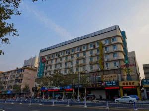 a large building on a city street with at Jingjiang Inn Nantong Renmin Middle Road in Nantong