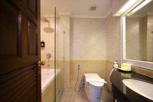 a bathroom with a toilet and a sink at Sira Boutique Chiang Mai in Chiang Mai