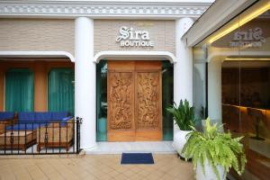 a store front with a wooden door in front at Sira Boutique Chiang Mai in Chiang Mai