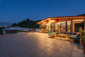 德拉敦The Homely Homestay Near Pacific Mall Dehradun的一座带家具和灯的庭院的建筑