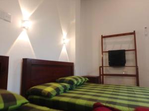 Ένα ή περισσότερα κρεβάτια σε δωμάτιο στο Ceylon Green Gate Hotel