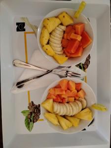 two plates of fruit and vegetables on a table at The Wasa Heaven in Hiriketiya +42 photos