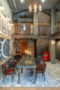 a dining room with a table and chairs at House of Machine Boutique Hotel in Bangkok