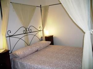 a bedroom with a bed with a canopy at Glicine in Miasino