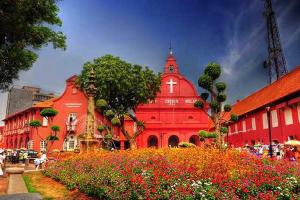 a large red building with flowers in front of it at Persona Boutique Hotel in Malacca