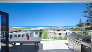 a patio with a table and a grill on a balcony at Elanora 3 - Beachfront Unit With Views! in Avoca Beach
