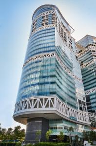 a large building with a clock on it at Citadines Fusionopolis Singapore in Singapore