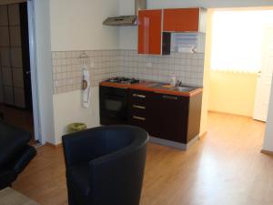 a kitchen with a stove and a counter top at Rooms Vendi in Daruvar