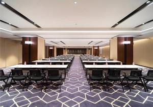 a room with rows of tables and chairs at E-Cheng Hotel Shenyang North Railway Station in Shenyang