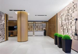 a lobby with potted plants in a building at Echarm Hotel Changsha Xiangya Fushan in Changsha +38 photos