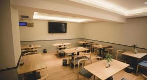 a classroom with tables and chairs and a flat screen tv at GreenTree Inn Express Datong High-Speed Railway Station Old City Wall in Datong