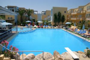 a large pool with blue water in a resort at Futura Hotel in Maleme