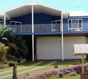 Cette maison bleue dispose d'un balcon. dans l'établissement Falcon Bay Family Retreat, à Falcon