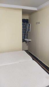 Ένα ή περισσότερα κρεβάτια σε δωμάτιο στο Hotel O White Carnations Hotels