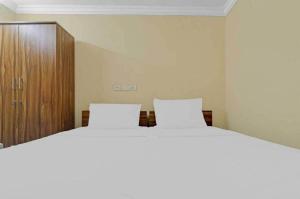 Ένα ή περισσότερα κρεβάτια σε δωμάτιο στο Hotel O White Carnations Hotels