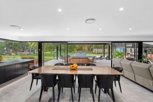 a dining room with a table and chairs at Racecourse Resort in Darawank +6 photos