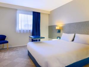 Ένα ή περισσότερα κρεβάτια σε δωμάτιο στο ibis Styles Tours Centre