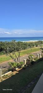 a view of a park with the ocean in the background at 204 L'escalier Cabanas- Beach front paradise in Amanzimtoti