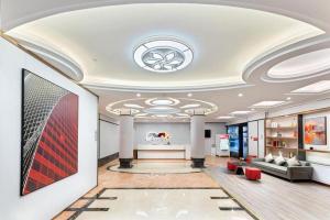 a living room with a couch and a table at Borrman Hotel Huizhou Danshui High-speed Railway Huiyang Station in Huizhou