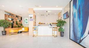 a room with a kitchen and a counter with plants at Green Tree Inn Anhui Tianchang Economic Development Zone in Tianchang
