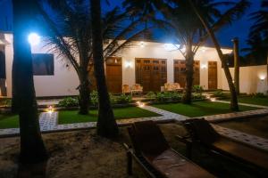 ein Haus mit Palmen in der Nacht in der Unterkunft Happy Mama Guest Mirissa in Mirissa