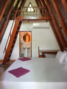 a bedroom with a large bed with a staircase at Rock Pool Residence in Tangalle