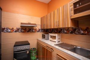 a kitchen with a sink and a stove top oven at Cabral residence in Guediawaye +10 photos