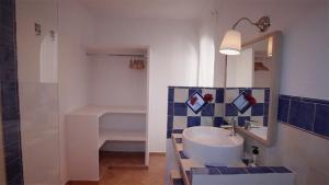 a bathroom with a sink and a mirror and a shower at Casa Entre Armonías in Zahara de los Atunes