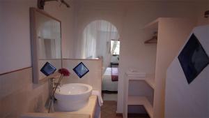 a bathroom with a sink and a toilet in it at Casa Entre Armonías in Zahara de los Atunes