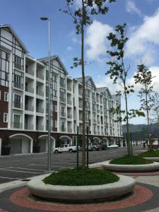 a large apartment complex with trees in a parking lot at Cameron New Apartment @ Golden Hill in Cameron Highlands