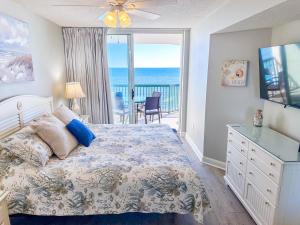 a bedroom with a bed and a view of the ocean at Ashworth 905 in North Myrtle Beach +40 photos