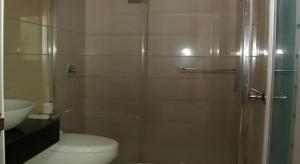 a bathroom with a shower and a toilet and a sink at Yidun Hotel Foshan Luocun in Huanshi
