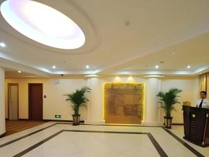 a large room with two palm trees on the wall at Wanxiang Hotel in Maluan
