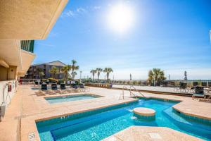 a pool at a resort with chairs at Ashworth 905 in North Myrtle Beach