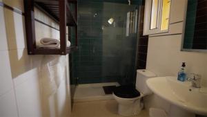 a bathroom with a toilet and a sink and a shower at Casa Entre Armonías in Zahara de los Atunes