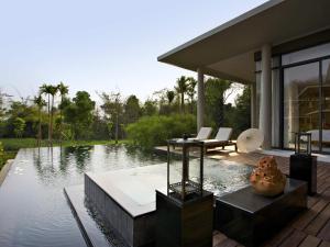 a house with a swimming pool next to a house at Veranda High Resort Chiang Mai - MGallery Collection, Accor Hotel in Hang Dong
