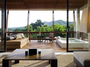 a living room with a couch and a tub at Veranda High Resort Chiang Mai - MGallery Collection, Accor Hotel in Hang Dong