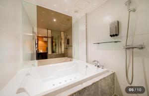 a white bathroom with a tub and a shower at Motel Cookie in Seoul +28 photos