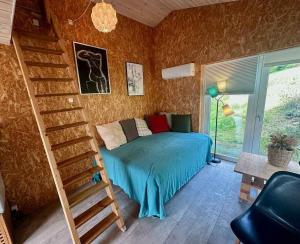 Un dormitorio con una cama y una escalera en una habitación. en Small Oasis Near Coast And Town, en Ebeltoft