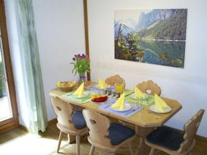 a wooden table with chairs and food on it at Ferienwohnung Gsenger In Abtenau in Abtenau