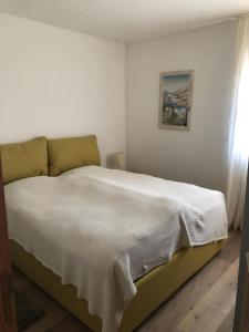 a bedroom with a large bed with white sheets at Motta Rotonda in Maloja