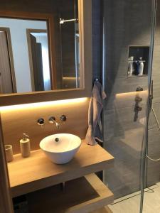 a bathroom with a white sink and a shower at Motta Rotonda in Maloja +8 photos