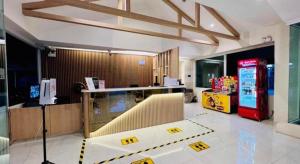 a lobby with a counter and a soda machine at Natee Place in Chiang Mai