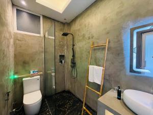 a bathroom with a toilet and a sink and a shower at Hello Mirissa in Mirissa +60 photos