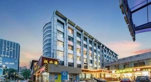 een hoog gebouw in een stad met een straat bij Zhenxing Hotel in Shenzhen