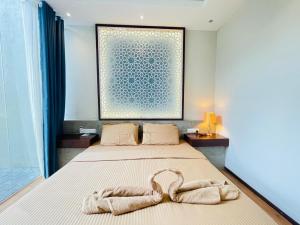 a bedroom with a bed with two towels on it at Hello Mirissa in Mirissa