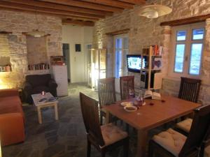 a living room with a wooden table and chairs at Naousa in Naousa